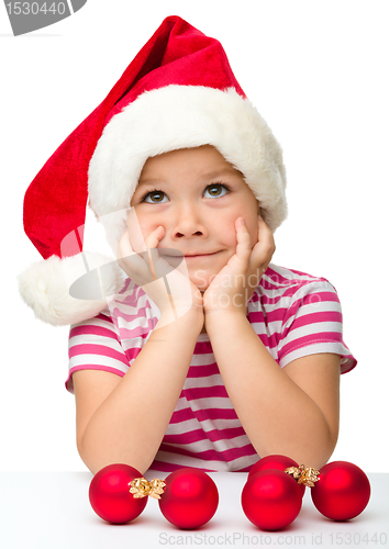 Image of Cute little girl wearing santa hat