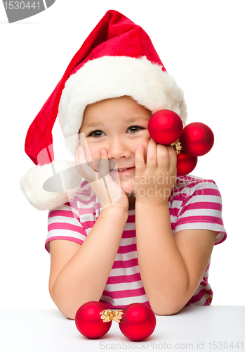 Image of Cute little girl wearing santa hat