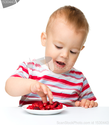 Image of Cute little boy with strawberries