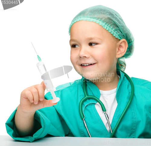 Image of Little girl is playing doctor with syringe