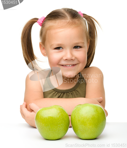 Image of Little girl with two green apples