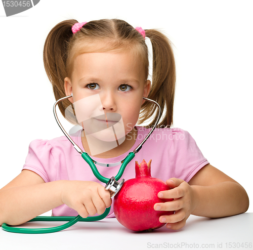 Image of Little girl with pomegranate