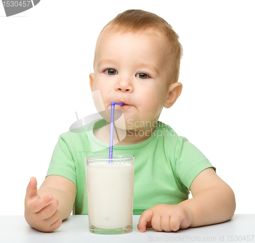Image of Cute little boy is drinking milk
