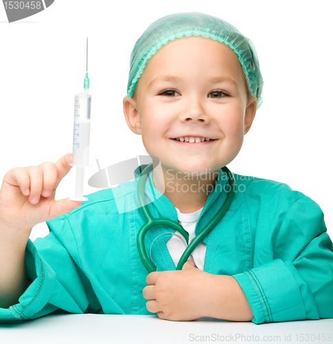 Image of Little girl is playing doctor with syringe