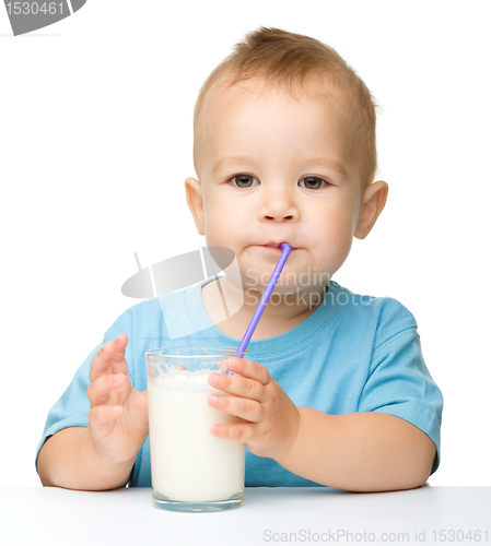 Image of Cute little boy is drinking milk