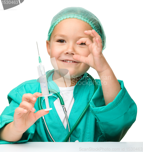 Image of Little girl is playing doctor with syringe