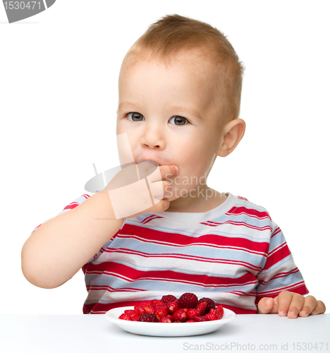 Image of Happy little boy with strawberries