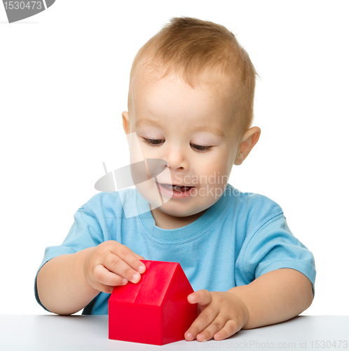 Image of Little boy plays with building bricks