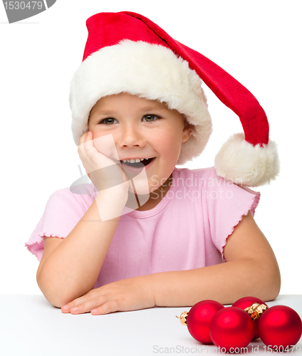 Image of Cute little girl wearing santa hat