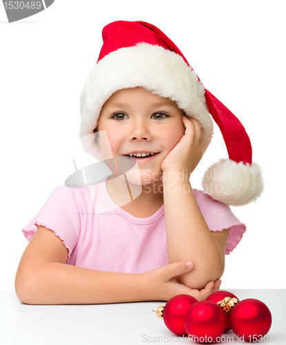Image of Cute little girl wearing santa hat