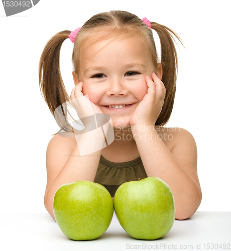 Image of Little girl with two green apples