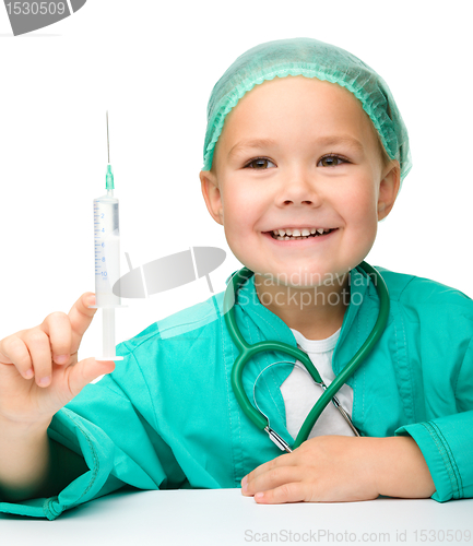 Image of Little girl is playing doctor with syringe