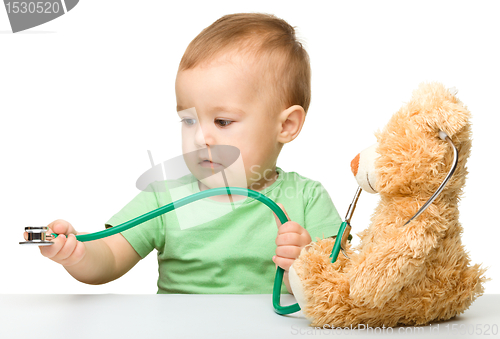 Image of Little boy is playing doctor with stethoscope