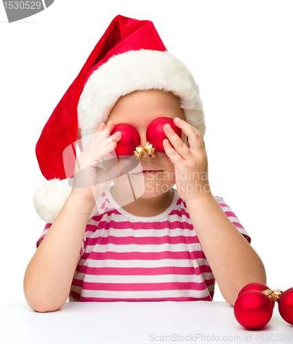 Image of Cute little girl wearing santa hat