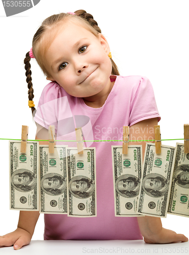 Image of Cute little girl with paper money - dollars