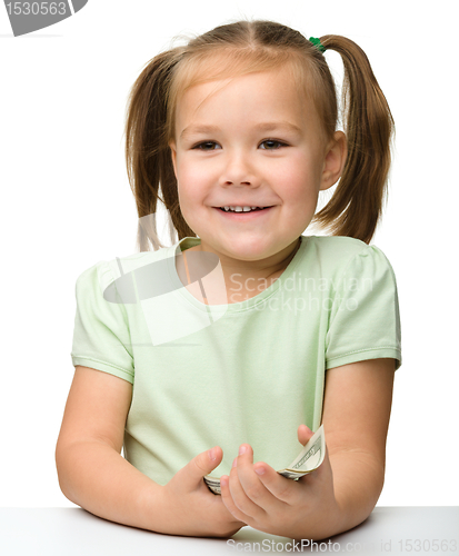 Image of Cute little girl with paper money - dollars