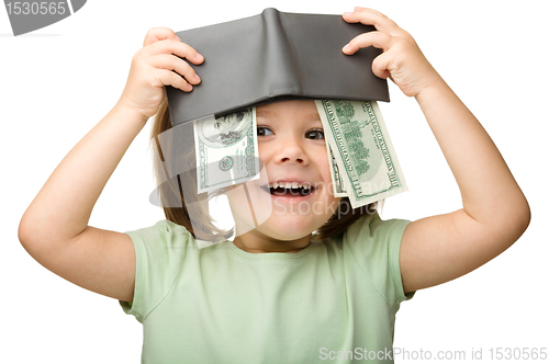 Image of Cute little girl plays with money