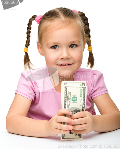 Image of Cute little girl with paper money - dollars