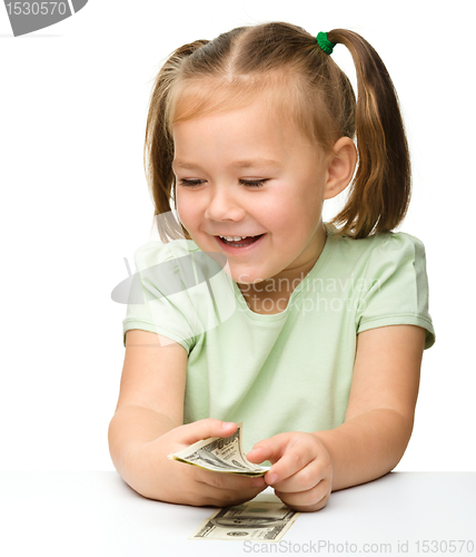 Image of Cute little girl with paper money - dollars