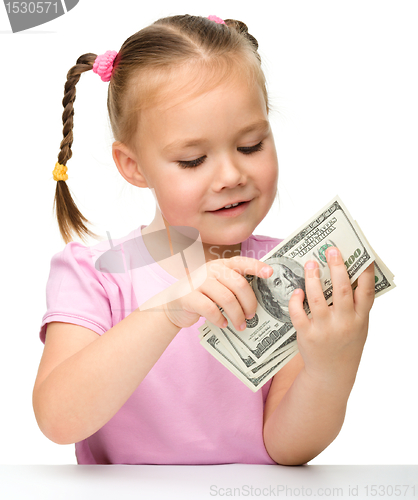 Image of Cute little girl with paper money - dollars