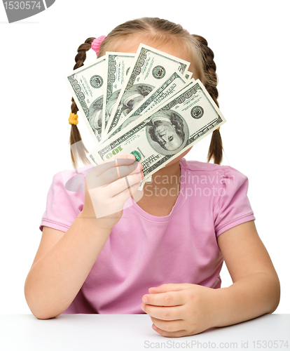 Image of Cute little girl with paper money - dollars