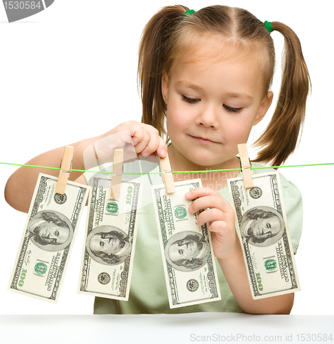 Image of Cute little girl with paper money - dollars