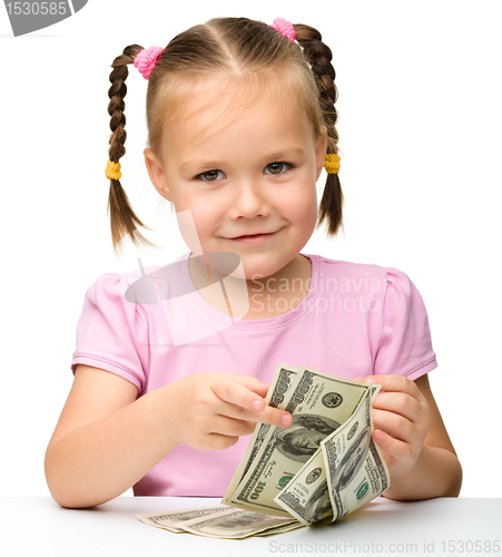 Image of Cute little girl with paper money - dollars