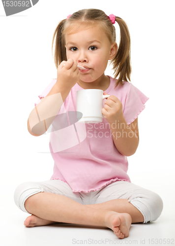 Image of Cute little girl is eating