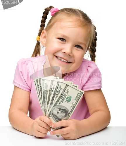 Image of Cute little girl with paper money - dollars