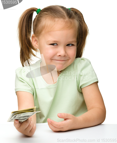 Image of Cute little girl with paper money - dollars