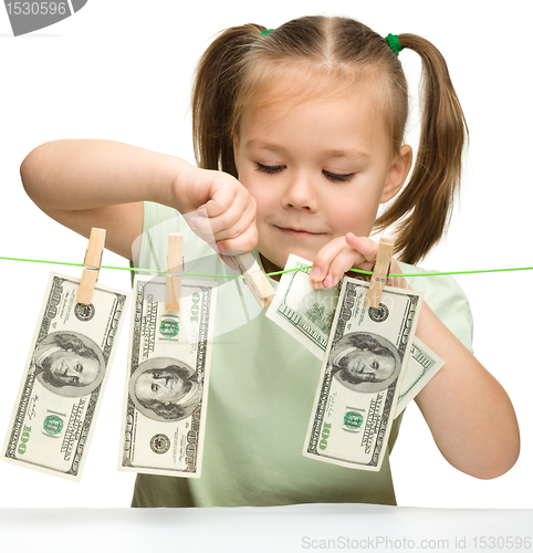 Image of Cute little girl with paper money - dollars