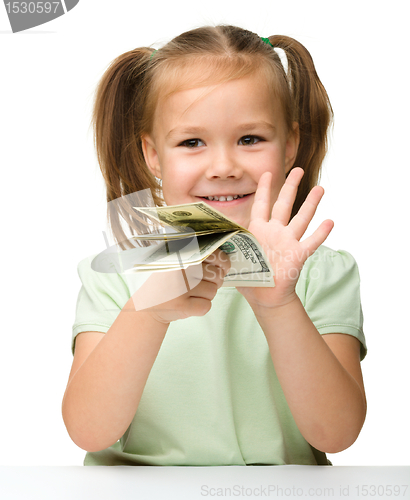 Image of Cute little girl with paper money - dollars