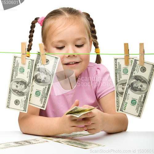 Image of Cute little girl with paper money - dollars