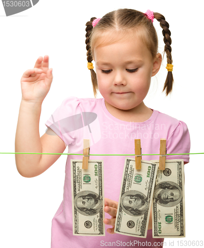 Image of Cute little girl with paper money - dollars