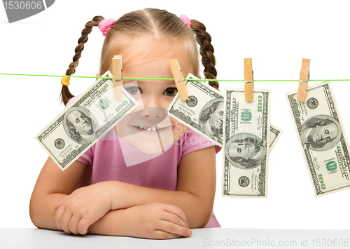 Image of Cute little girl with paper money - dollars