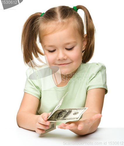 Image of Cute little girl with paper money - dollars