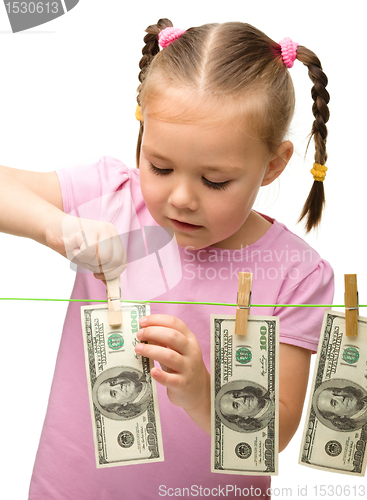 Image of Cute little girl with paper money - dollars