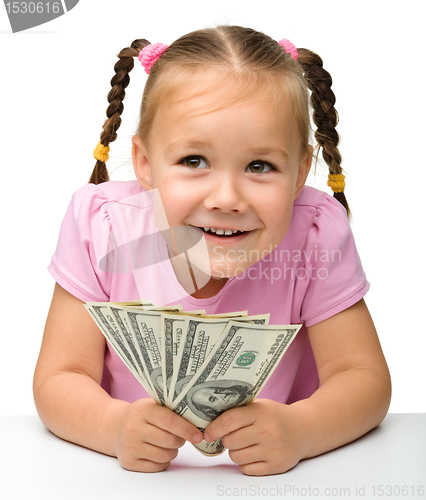 Image of Cute little girl with paper money - dollars