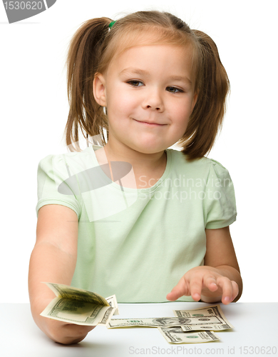 Image of Cute little girl with paper money - dollars