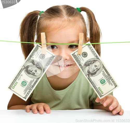 Image of Cute little girl with paper money - dollars