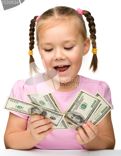 Image of Cute little girl with paper money - dollars