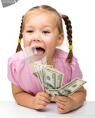 Image of Cute little girl with paper money - dollars
