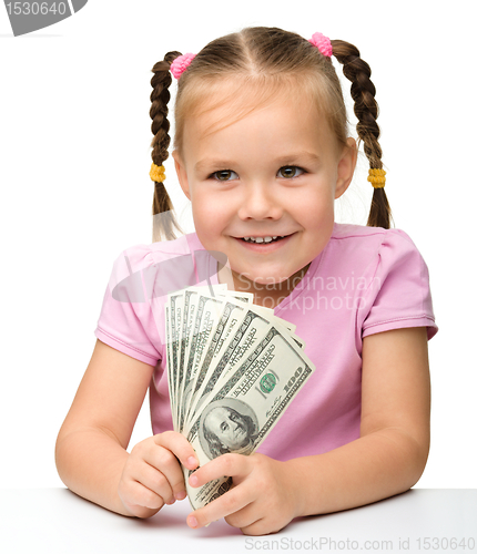 Image of Cute little girl with paper money - dollars