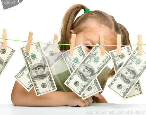 Image of Cute little girl with paper money - dollars