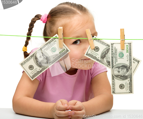 Image of Cute little girl with paper money - dollars