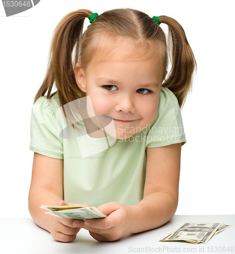 Image of Cute little girl with paper money - dollars