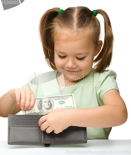 Image of Cute little girl plays with money