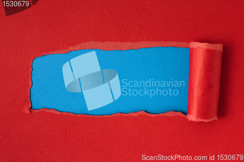 Image of Red torn paper with blue space for text 