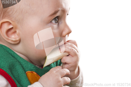 Image of baby sitting and eating an apple
