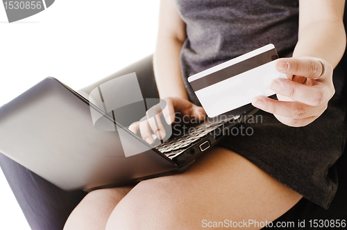 Image of Chinese woman shopping online with a credit card.